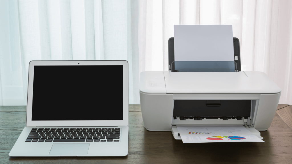 Laptop on Wooden Table with Printer.