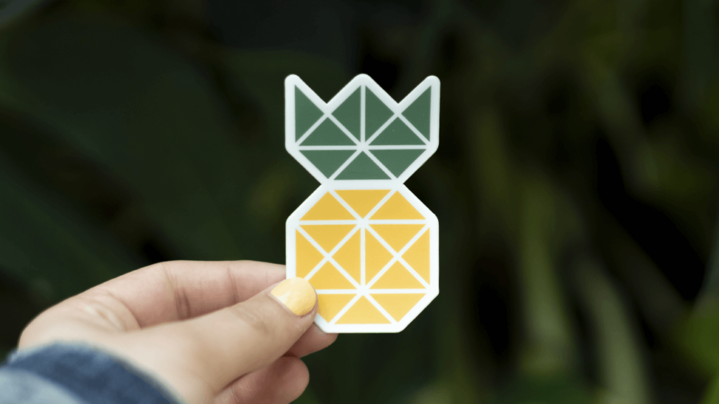 Person holding pineapple sticker